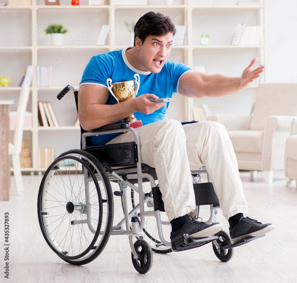 Disabled man watching sports on tv Disabled man watching sports on tv