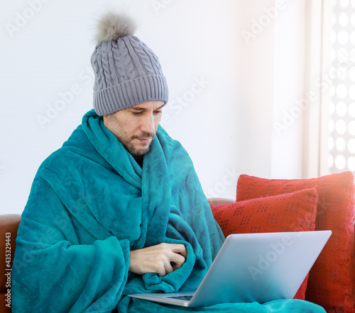Obraz na płótnie Caucasian unwell sick unhappy male employee wears knitted hat cover by warm blan