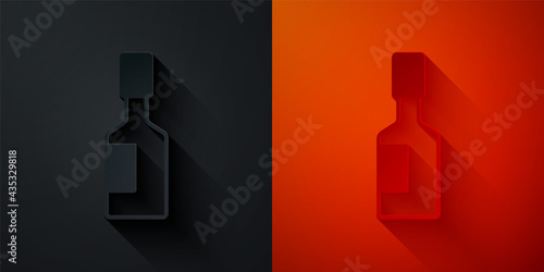 Paper cut Tabasco sauce icon isolated on black and red background. Chili cayenne spicy pepper sauce. Paper art style. Vector
