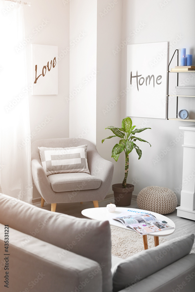 Obraz premium Interior of modern room with pictures and armchair