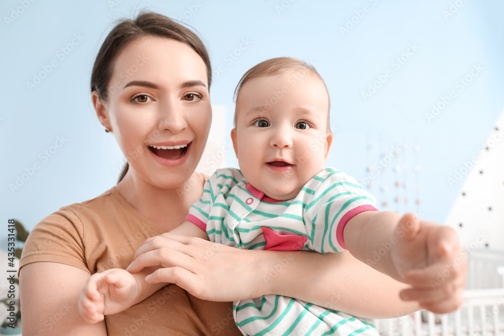 Happy mother with cute baby at home, closeup Happy mother with cute baby at home, closeup