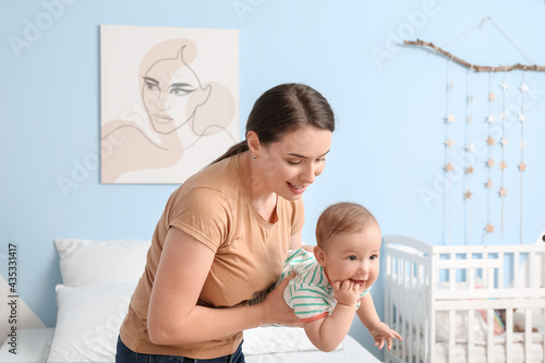 Mother with cute baby at home