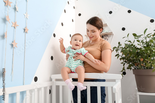 Mother with cute baby at home