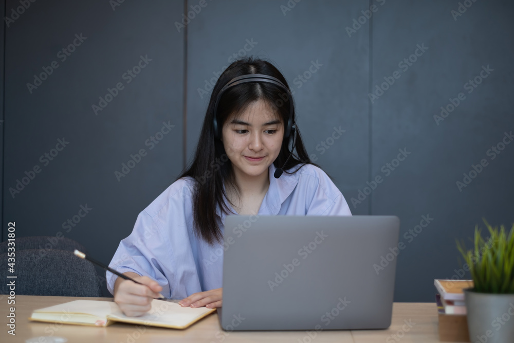 E-learning ,online ,education and internet social distancing protect from COVID-19 viruses concept. Asian woman student video conference e-learning with teacher on laptop computer at home. E-learning ,online ,education and internet social distancing protect from COVID-19 viruses concept. Asian woman student video conference e-learning with teacher on laptop computer at home.