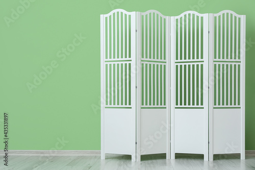 Modern folding screen near color wall