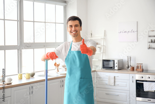 Young man with floor mop sh...