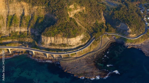 Bird's Eye View Of Sea Cliff Bridge With Lawrence Hargrave Drive At Sunrise In Clifton, Australia. - aerial photo