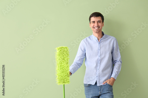 Young man with floor mop on...
