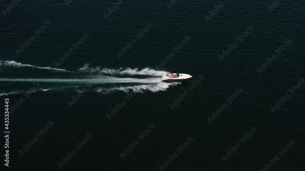 White boat with an awning, moving on the water. Boat in motion top view, drone shooting. Large boat White boat with an awning, moving on the water. Boat in motion top view, drone shooting. Large boat