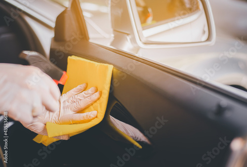Fototapeta Naklejka Na Ścianę i Meble -  Woman hands using cloth cleaning inside a car,Safety and protect infection during covid-19 virus pandemic situation