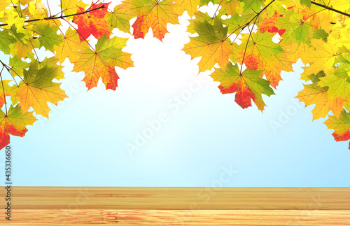 Vintage wooden table top and maple leaves on blurred autumn backdrop