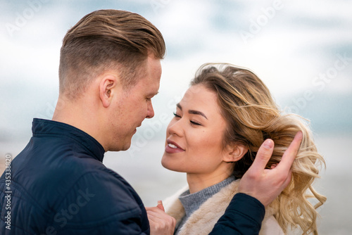 Two Young couple standing enjoying on a sand and enjoying each other.Summer,spring,autumn vacation.Closeup.