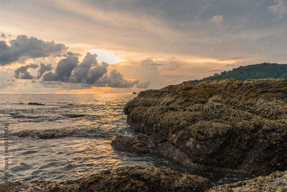 Colorful sunset landscape with corall big stone and sea. Travel concept, Copy space