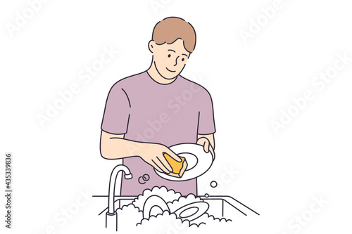 Washing dishes and housework concept. Young smiling man cartoon character standing washing dishes with special soap and brush over white background vector illustration 