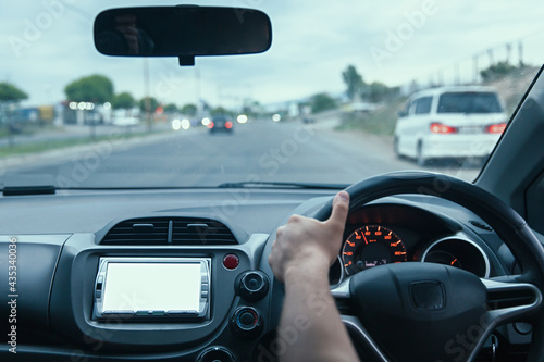 man hand driving a car