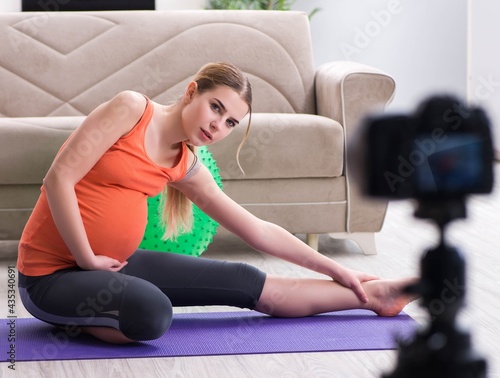 Pregnant woman recording video for blog and vlog