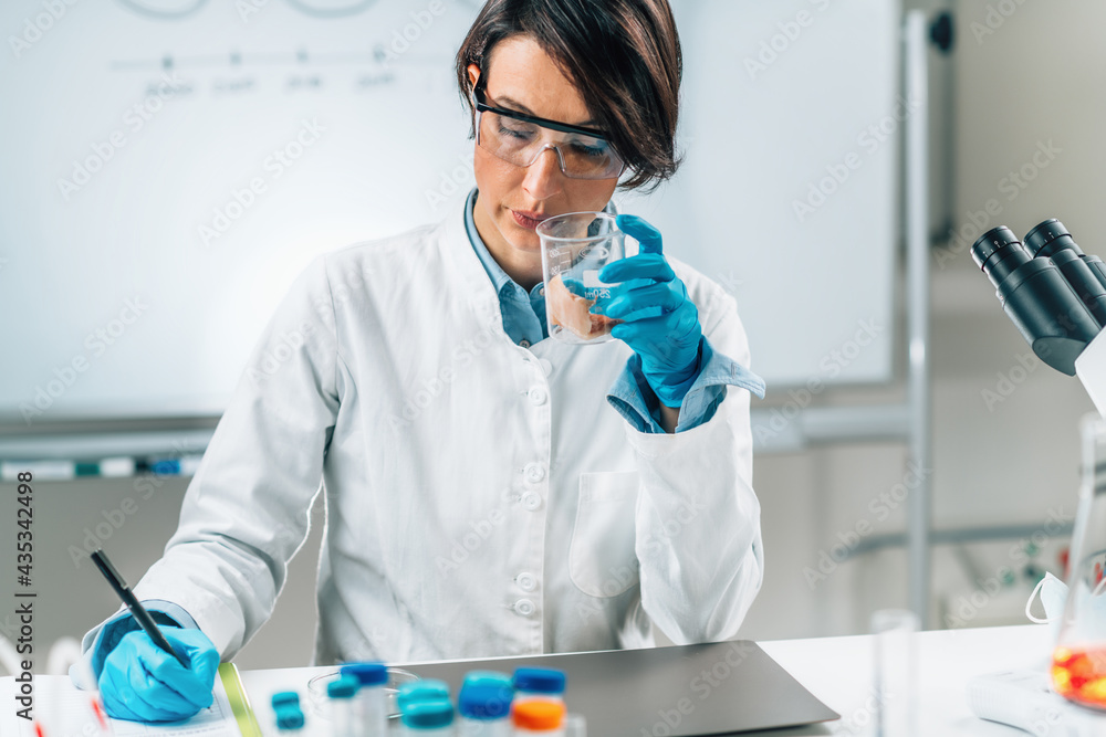 Sensory Analysis of Sea Fish Sample in a Test Tube. Food Safety Inspector Smelling Sample in Laboratory - obrazy, fototapety, plakaty 