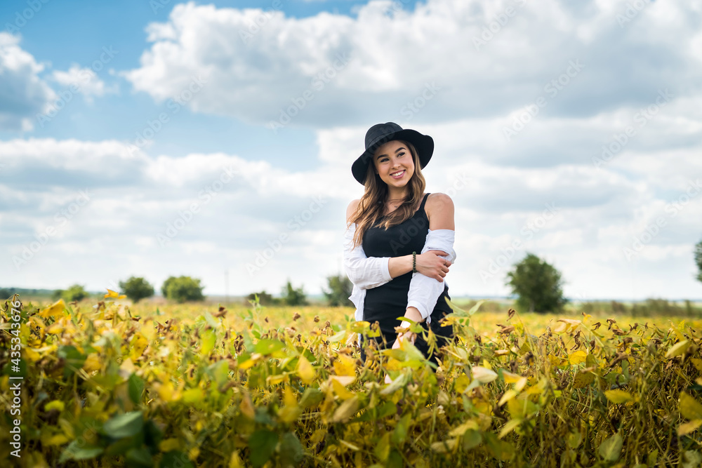 Beautiful carefree woman posing in rural fields in summer Beautiful carefree woman posing in rural fields in summer