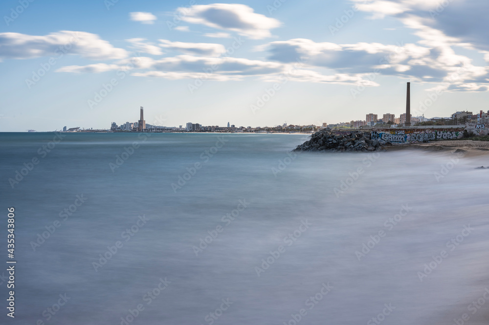Long exposure landscape photography of the city of Barcelona from the beach