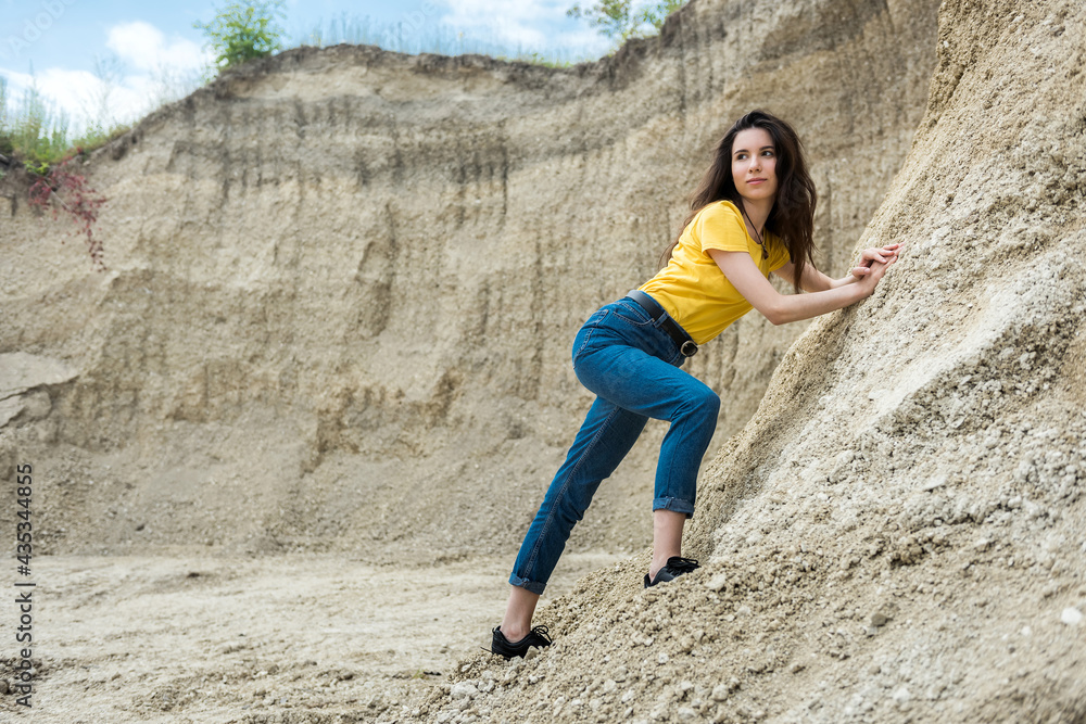 Pretty woman poses against sand canyon background of rocks Pretty woman poses against sand canyon background of rocks