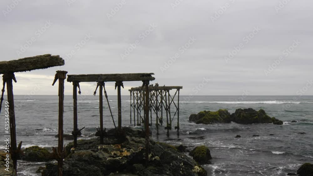 Ruins of the historic, 120-year-old pier in Llico, Vichuquen, Chile, scenic shot Ruins of the historic, 120-year-old pier in Llico, Vichuquen, Chile, scenic shot