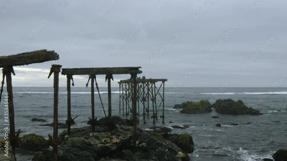 Ruins of the historic, 120-year-old pier in Llico, Vichuquen, Chile, wide shot Ruins of the historic, 120-year-old pier in Llico, Vichuquen, Chile, wide shot