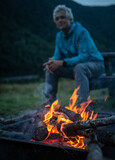 Men sitting near camping fire