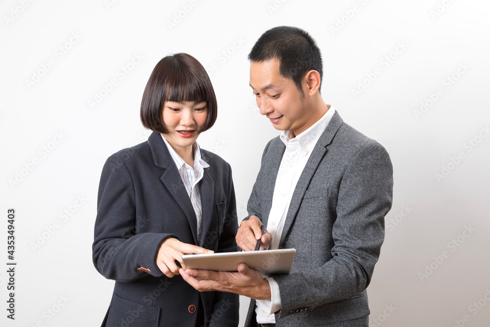 Businessman and woman holding tablet while discussing marketing plan standing on white background. Businessman and woman holding tablet while discussing marketing plan standing on white background.