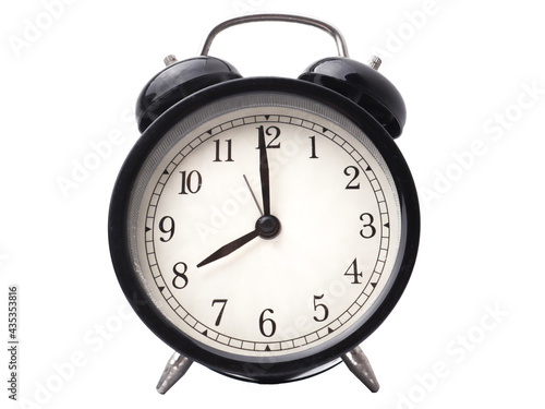 Close up retro vintage black alarm clock isolated on white