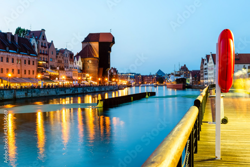 Gdansk night city riverside view. View on famous crane and facades of old medieval houses