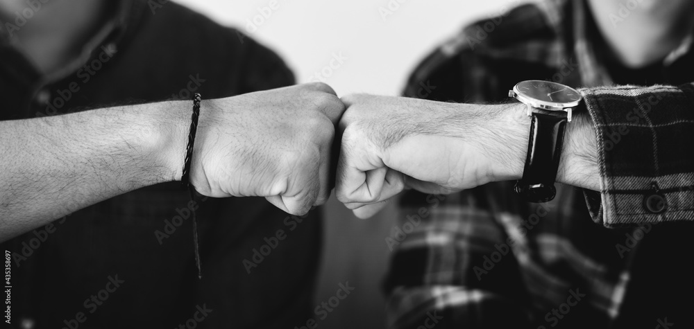 Closeup of men fist bumping Closeup of men fist bumping