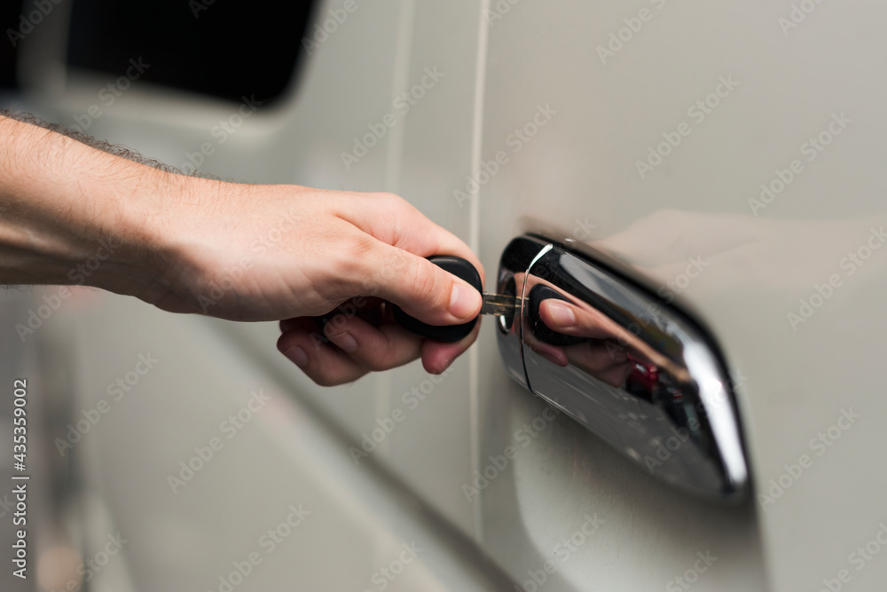 Fotografie Unlocking a car door with a key