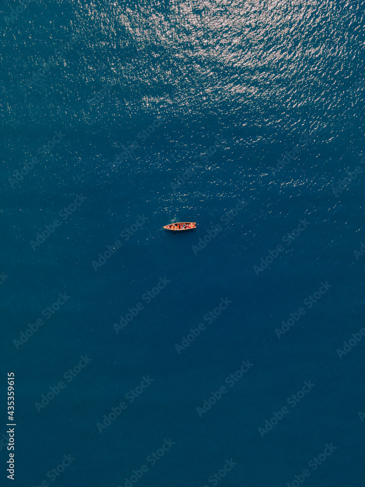 lonely boat in middle of ocean 