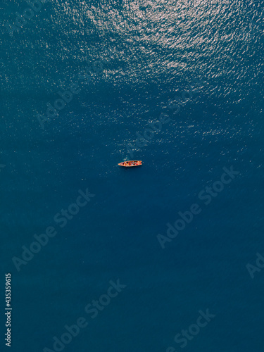 lonely boat in middle of ocean 
