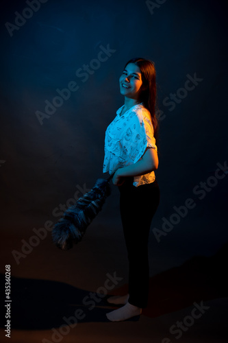 Girl in a shirt with pipidustre illuminated by complementary light