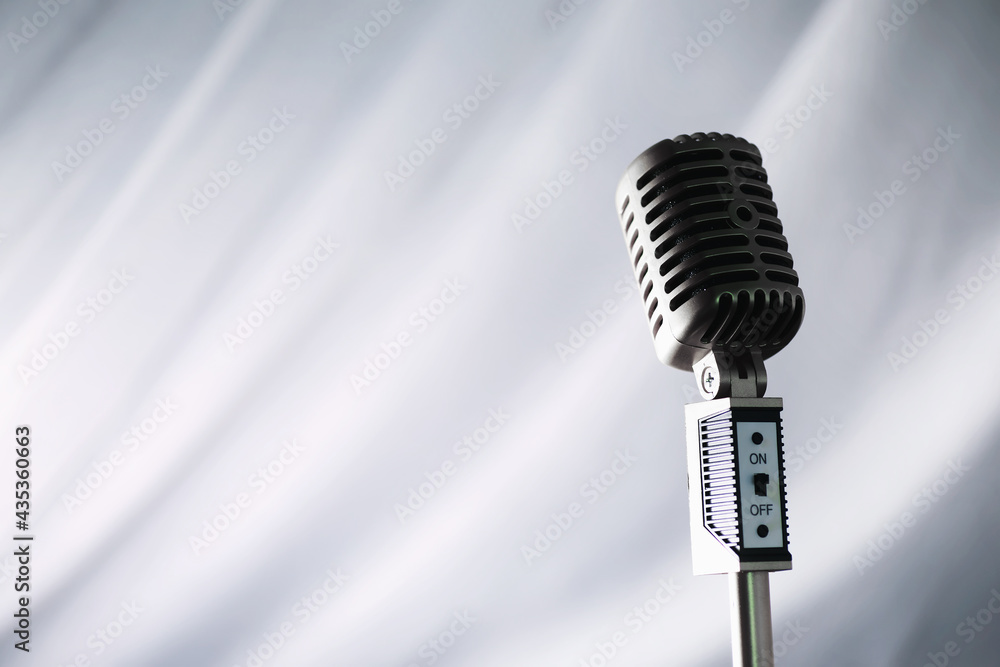 Fototapeta premium Stand with a retro microphone. Microphone on a tripod. Performance of the artist with a vintage microphone. Scene with a microphone.