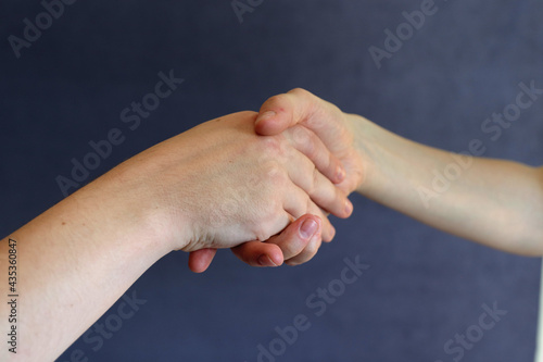 handshake close-up on dark background
