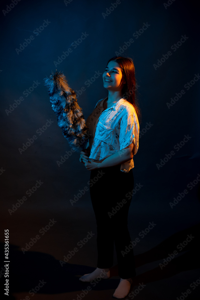 Girl in a shirt with pipidustre illuminated by complementary light