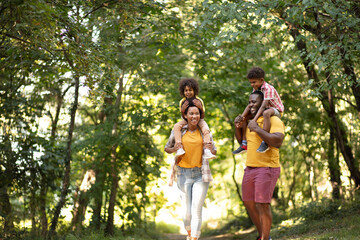  African American family walking trough park.