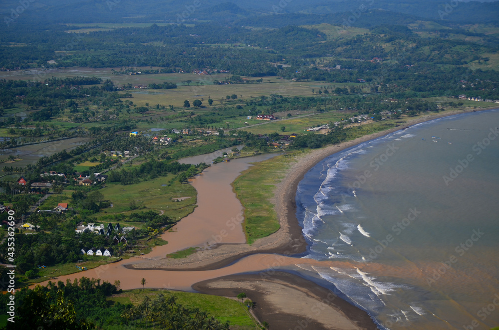 aerial view of the beach, village and river