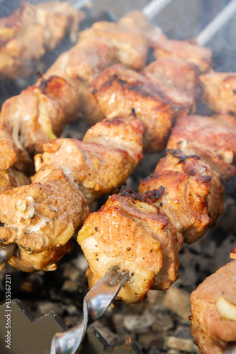 Obraz na płótnie Shish Kebab made from pieces of pork is cooked on skewers on the grill w salonie