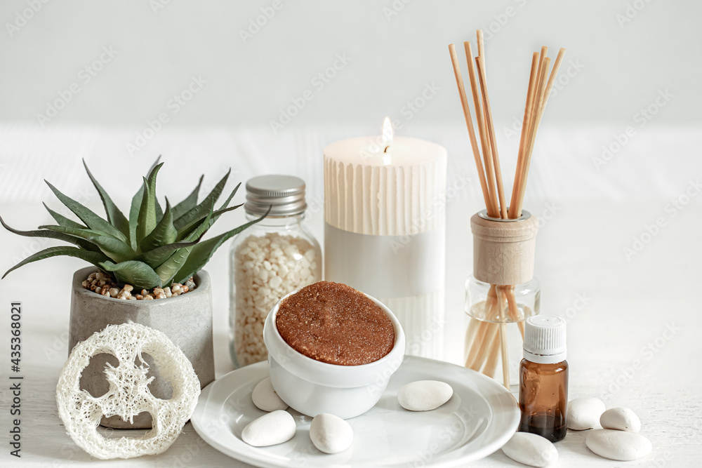 Spa composition with aroma sticks, aroma oil and body care products.