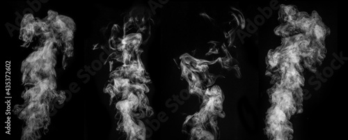 A perfect set of four different mystical curly white steam or smoke on a black background