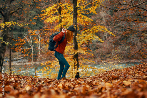 woman in a sweater jeans and with a hat on her head landscape fallen leaves model © SHOTPRIME STUDIO