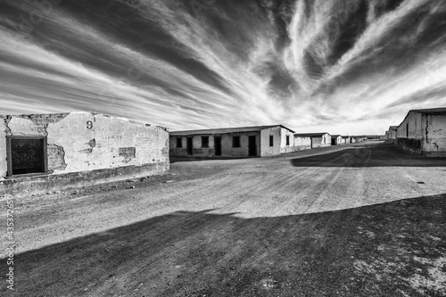 Black and white image of the ruins of abandoned houses from the nitrate era in Chacabuco in the Atacama desert in the north of Chile  photo