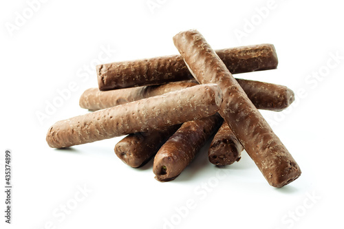 A slide of corn sticks in chocolate on a white background in a close-up with shadows isolated