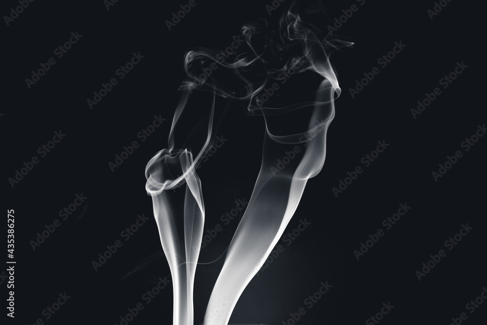 White smoke creating abstract shapes on a black background White smoke creating abstract shapes on a black background