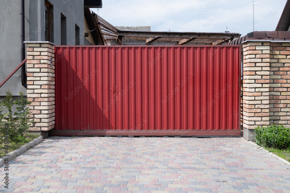 Fototapeta premium red gate. Private residential building