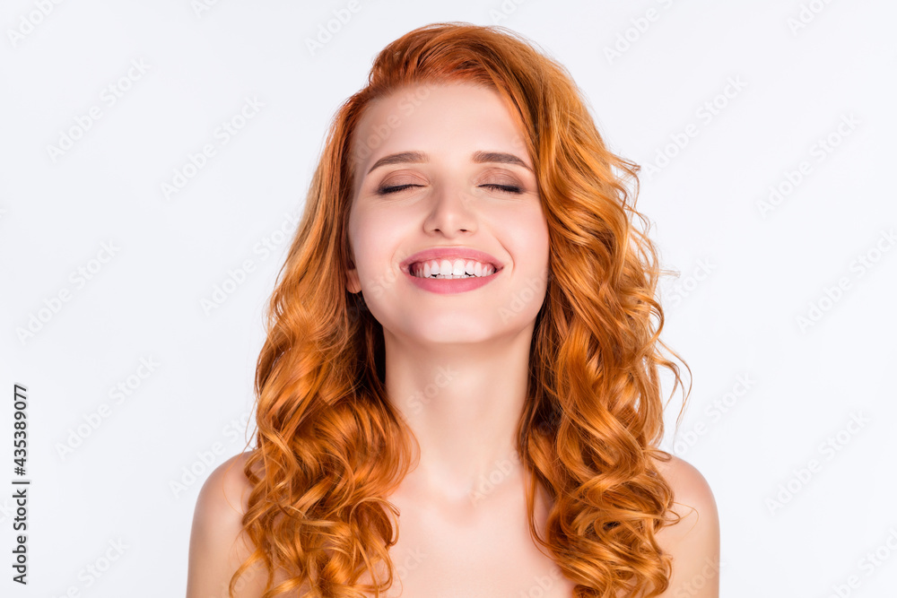 Photo portrait of red haired dreamy girl smiling with naked shoulders closed eyes isolated on white color background Photo portrait of red haired dreamy girl smiling with naked shoulders closed eyes isolated on white color background
