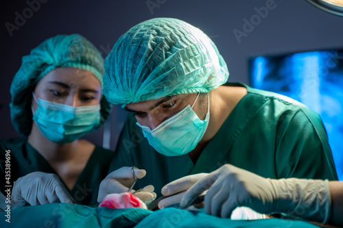 Medical team performing operation.,Diverse team of professional surgeon and nurses performing surgery on a patient in the hospital operating room.